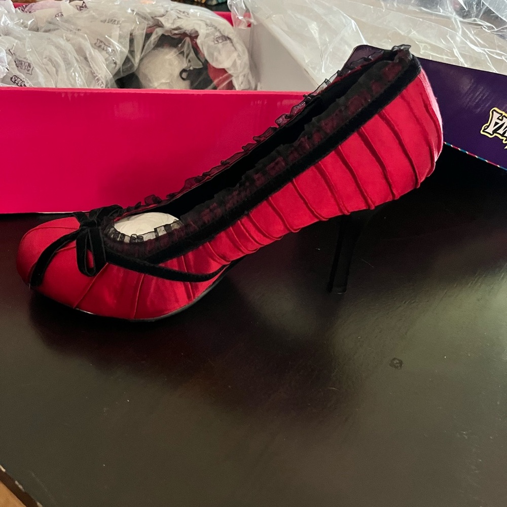 Only worn once inside red satin 4” heel with black bow